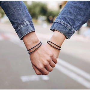 Matching couple bracelets with dark blue braided rope and rose gold magnetic charms