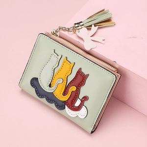 Short mint green women's wallet featuring cute cat patches and a stylish tassel zip