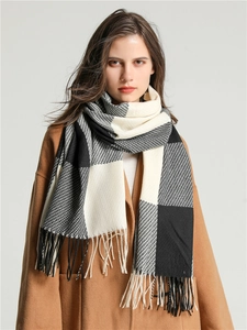Close-up of black and white plaid scarf featuring soft fringe and cashmere-like texture