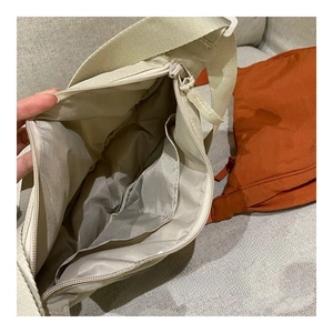 Macro view of nylon crossbody bag interior with multifunctional inner pockets