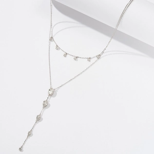 Close-up of double layer silver chain necklace with teardrop crystals and round zircon stones