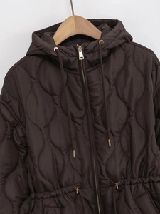 Detail of dark brown quilted jacket featuring a drawstring waist and hooded design