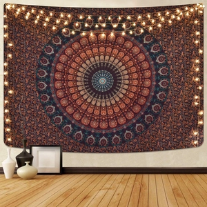 Bohemian mandala wall tapestry with warm fairy lights and detailed blue and orange patterns