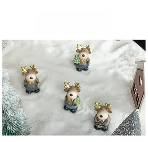 Close-up of four resin Christmas reindeer figurines in blue overalls on snowy backdrop