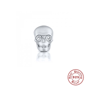 Macro detail of S925 sterling silver skull stud earring with sparkling diamond eyes