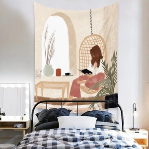 Detail of bohemian tapestry featuring a reading woman illustration hung over a bedroom bed