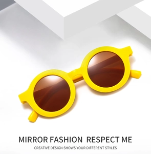 Detail of round yellow kids sunglasses with mocha lenses on a geometric stage