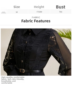 Detail of embroidered lace sleeve and waist belt on a black flared maxi dress