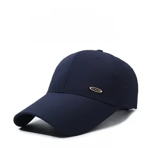 Detail of dark blue breathable mesh baseball cap with gold fashion metal emblem