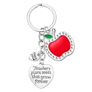 Detail of silver heart keychain with red apple charm and teacher appreciation engraving