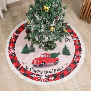 Detail of Christmas tree skirt featuring red truck design, plaid border, and white tassels