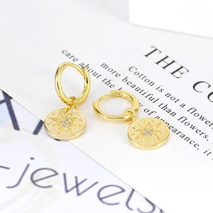 Gold plated S925 silver hoop earrings featuring micro-set zircon star pendants on a card