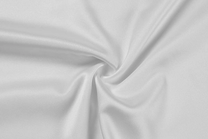 Close-up of premium white silk fabric showing smooth texture and elegant drape