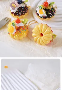Detail of realistic artificial strawberry donut pendant with cream and lemon slice on tray