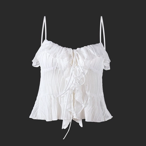 Detailed view of white ruffled camisole with front lace-up and vertical ribbed texture