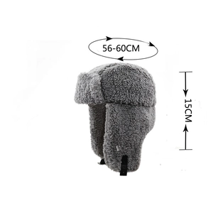 Detail view of grey lamb wool ushanka hat with chin strap and soft plush texture