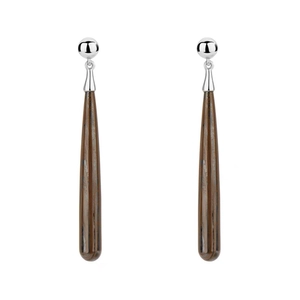 Macro detail of wood grain texture and teardrop dangle on silver ball stud earrings