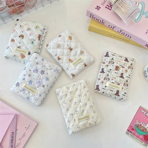 Close-up of quilted floral passport covers with cute cartoon bear and dog patterns