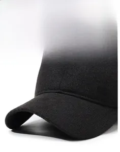 Detailed close-up of a sturdy hat brim and metal SORT logo on a warm black baseball cap