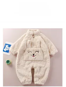 Detail of plush cream baby romper with cute rabbit embroidery and soft fleece texture
