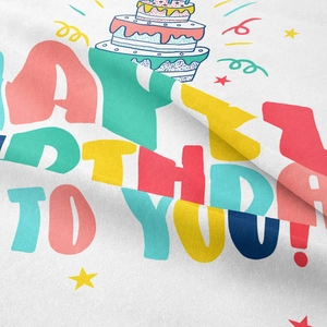 Detail of white birthday tapestry fabric with colorful happy birthday text and cake design