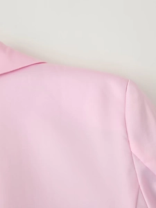 Detail view of the pink satin blazer collar and shoulder with elegant smooth texture