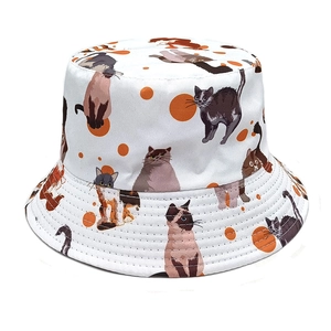 Detail of cute cartoon cat patterns and orange dots on white canvas bucket hat