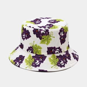 White cotton bucket hat featuring all-over purple cartoon grape print for sun protection