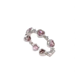 Adjustable silver ring with pink heart-shaped crystals and sparkling accents