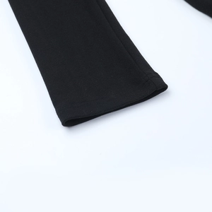 Detail of black knitted fabric cuff with precise stitching and high-quality texture