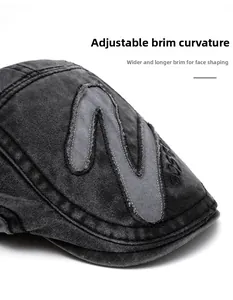 Detail of washed grey denim newsboy cap featuring flexible brim and Boston embroidery