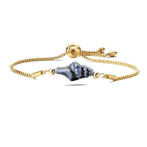 Detail of adjustable gold box chain bracelet with blue conch shell ceramic charm