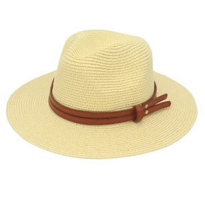 Detail of straw fedora hat featuring double brown faux leather bands and gold rivets
