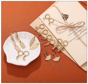 Detailed set of 18K gold plated stainless steel earrings with moon and sun charms