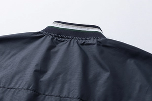Macro shot of striped ribbed collar and fine textured fabric on men's sport jacket