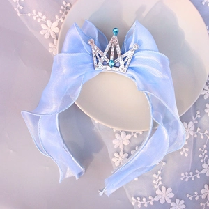 Detail of blue ribbon hairband with silver glitter crown and crystal for girls