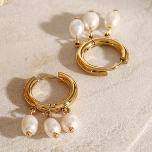 Elegant gold stainless steel hoop earrings with three hanging white pearls on stone
