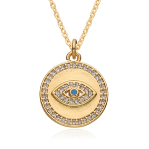 Macro detail of 18K gold plated evil eye pendant with blue stone and zircon inlay