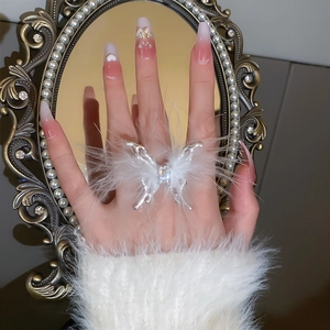 Detail of elegant feather butterfly open ring with sparkling crystal inlay on finger