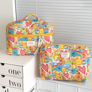 Quilted graffiti makeup bag set with colorful doodles and sturdy yellow zipper
