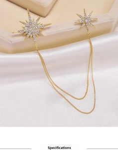 Detailed close-up of a luxury starburst brooch with sparkling zircons and delicate chains