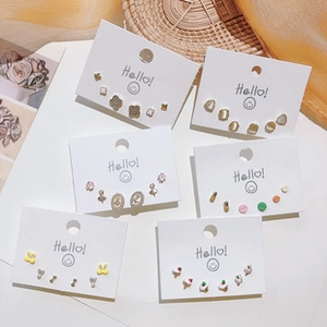 Detail of varied stud earring set featuring floral, butterfly and bunny shapes