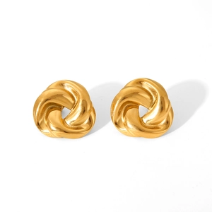 Close-up of golden stainless steel twisted knot earrings with polished surface