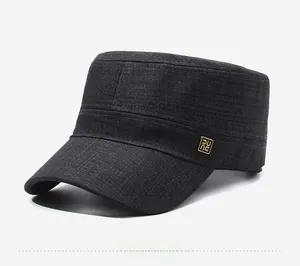 Detail view of dark grey flat cap featuring cotton twill texture and metal logo