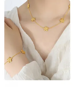 Detail of gold flower necklace and bracelet set featuring matte daisy petal texture
