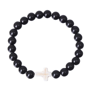 Detail of beaded bracelet with polished black round beads and white marble cross pendant