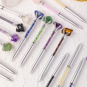 Silver metal ballpoint pens filled with colorful crystal raw stones and large gemstones