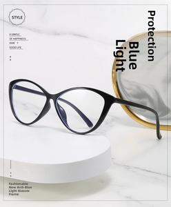 Detail of black cat-eye glasses frame with blue light blocking lenses on marble display