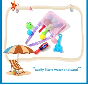 Detail of pink mesh beach bag with adjustable strap and colorful sand toys inside