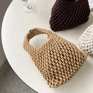 Detailed overhead view of handmade woven cotton rope tote bags in khaki, brown and white